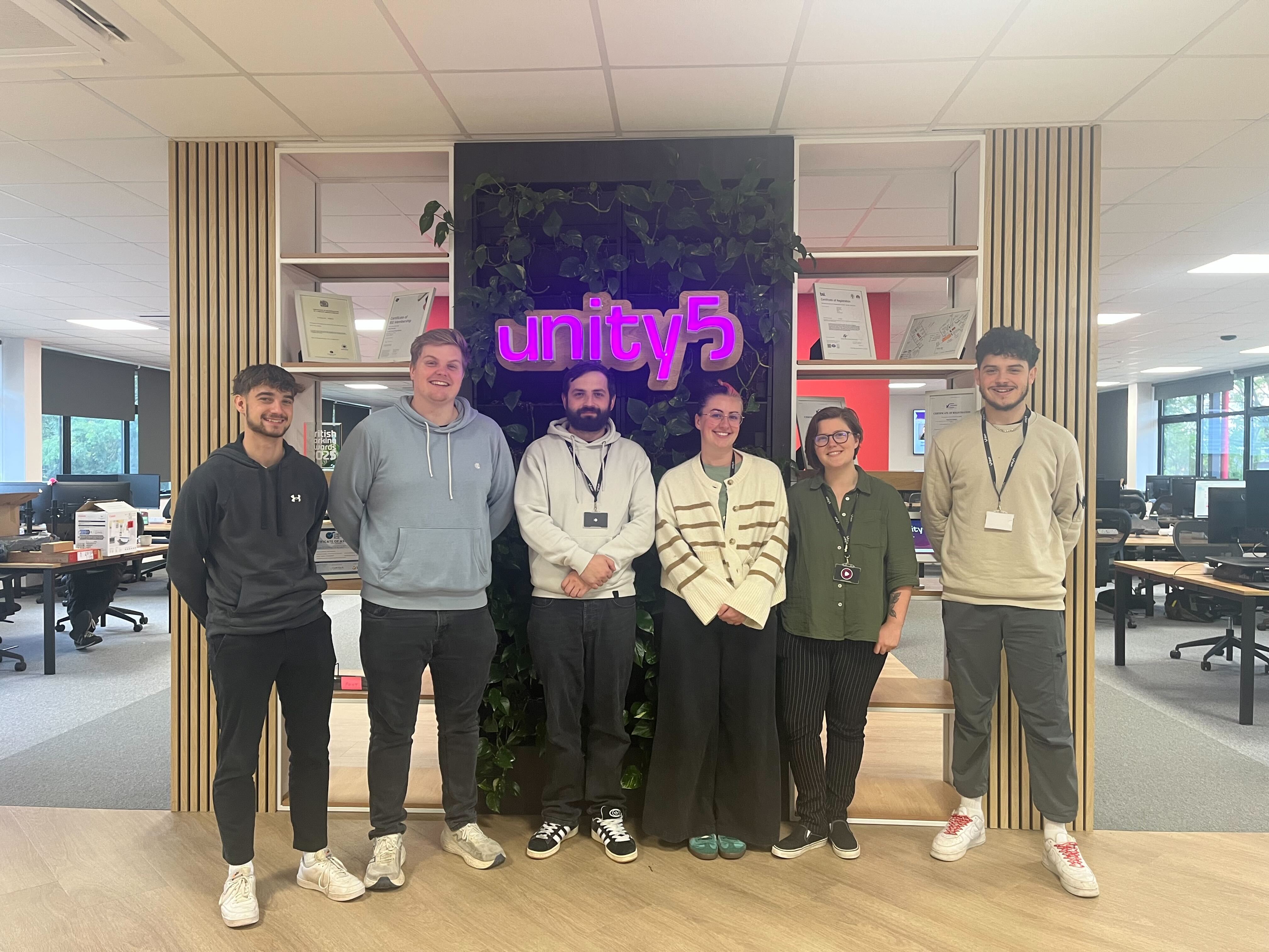 A group of people stand for a photo. They are members of our support team.